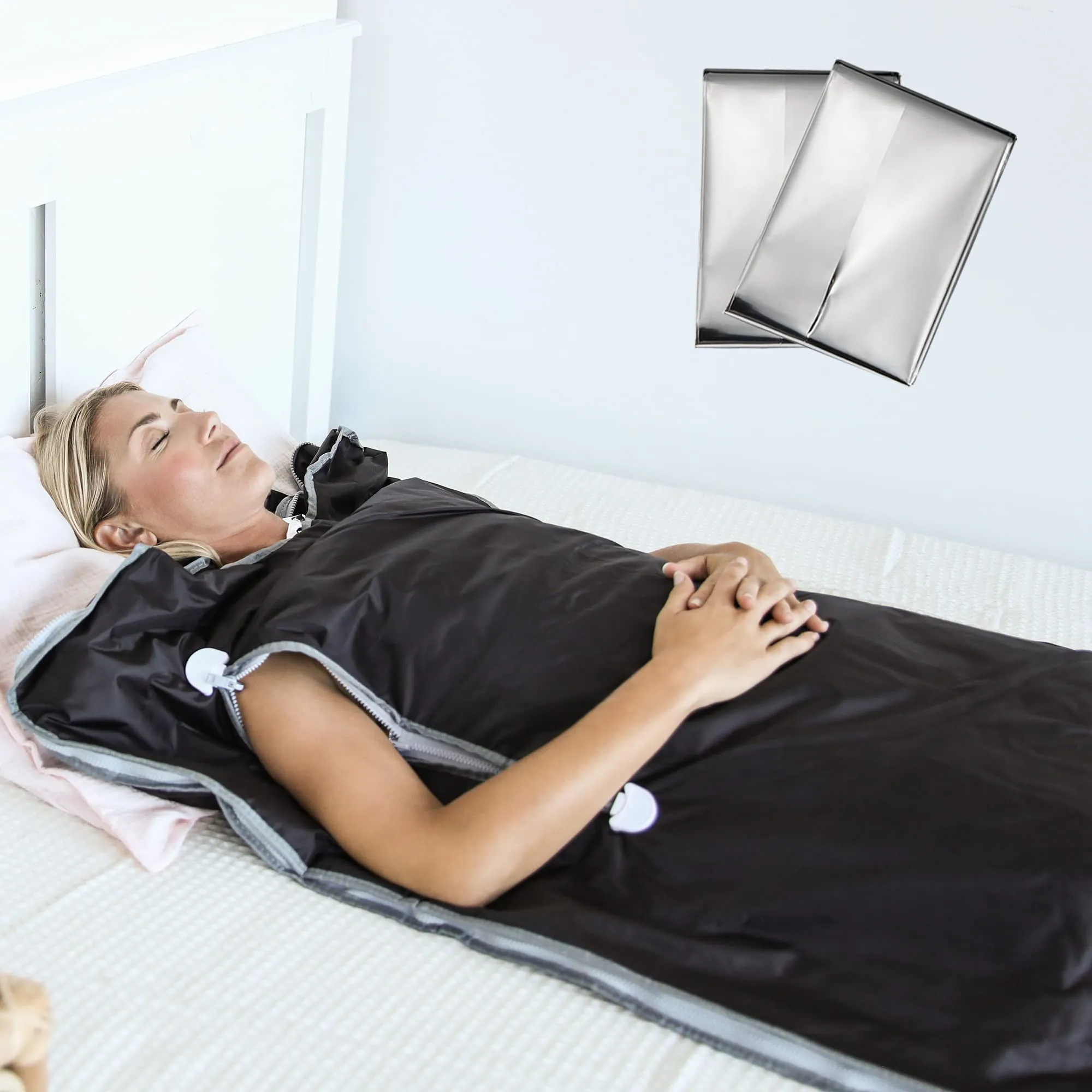 

An image of a person lying in an infrared sauna blanket, with a peaceful expression on their face, surrounded by a warm, glowing light. The image conveys the feeling of relaxation and comfort that comes from using an infrared sauna blanket
